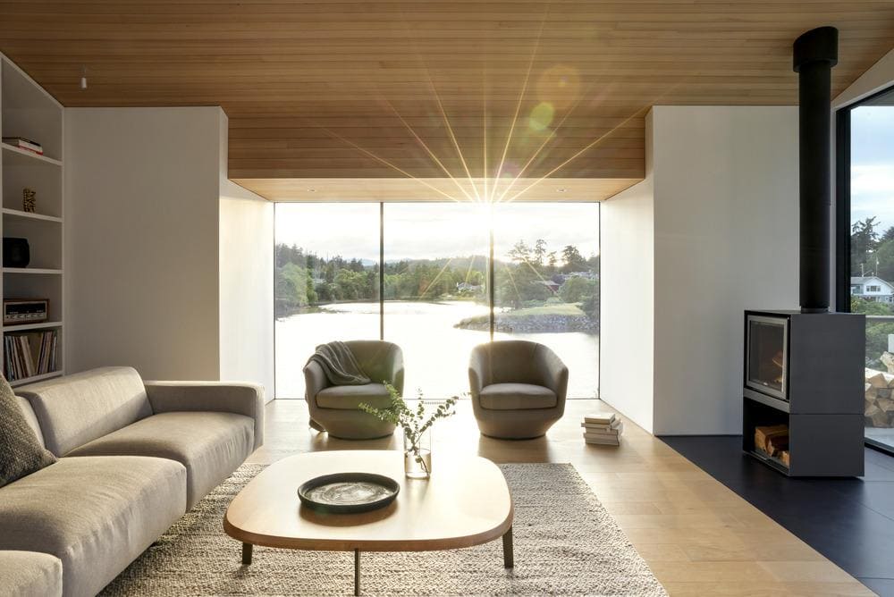 Interior view capturing ocean reflections through precise window framing