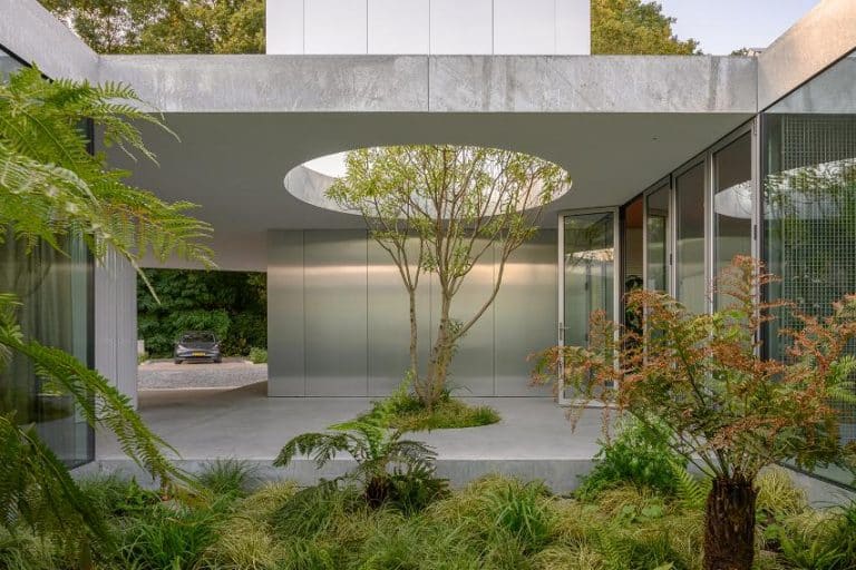 Studioninedots designs Villa Fifty-Fifty house as garden pavilion in Eindhoven ertical aluminium-clad tower rising through the horizontal slabs of the house
