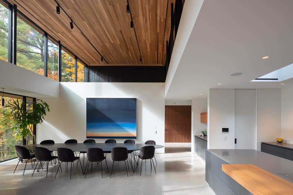 Open living dining and kitchen space filled with natural light and views