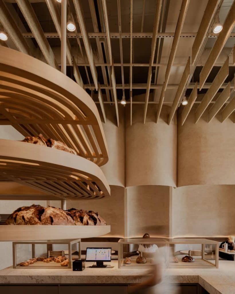 Lighting focused on artisan bread display within the bakery’s central area