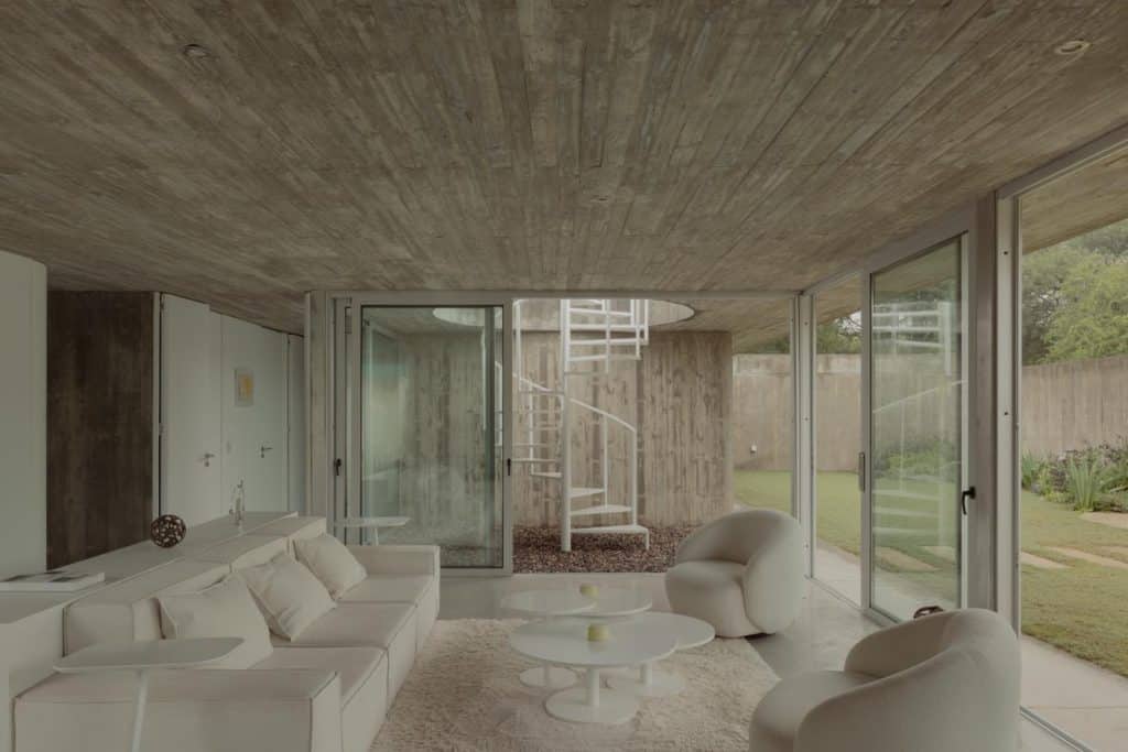 Concrete volume bending subtly to follow vehicular movement around the house