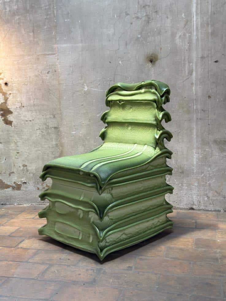 Side view highlighting the chair’s soft organic profile cut from rigid panels