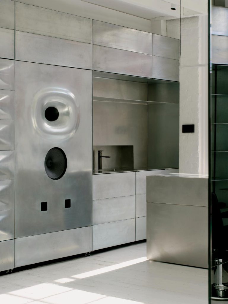 Continuous stainless steel mirror with gradated finishes on the Cutting Floor