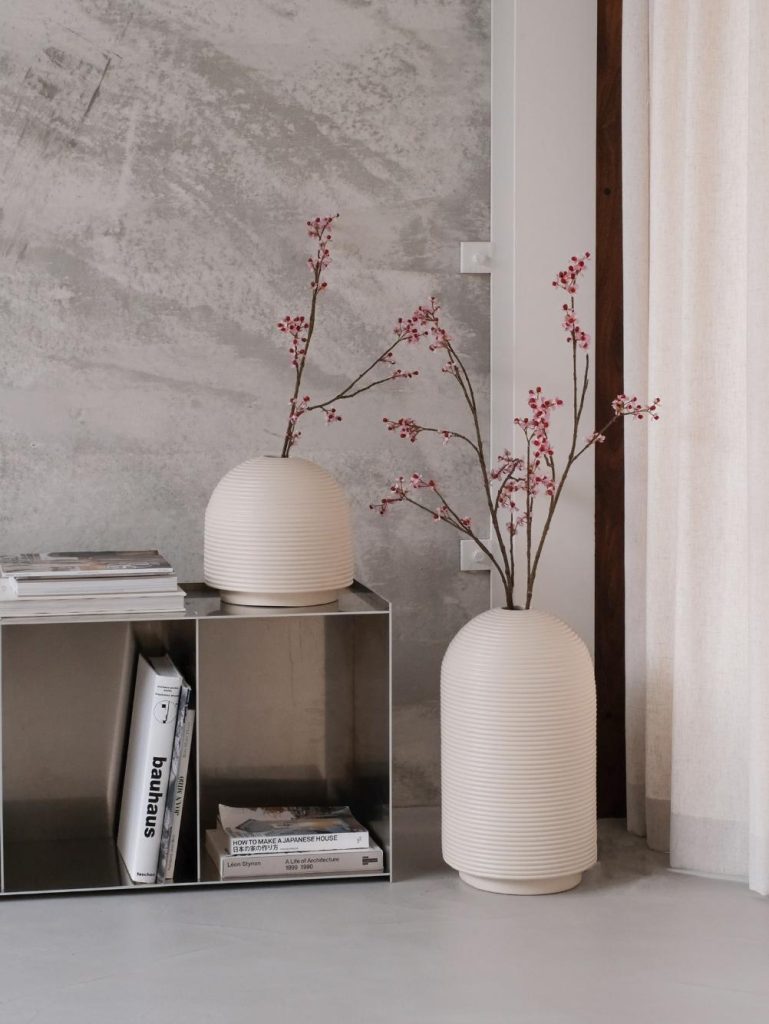 Tall Nova floor vase beside smaller tabletop pieces