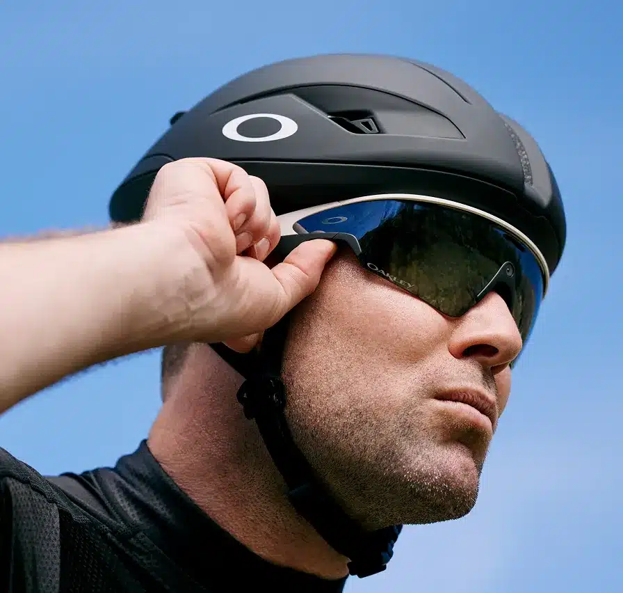 Oakley Meta Vanguard AI glasses with PRIZM lenses shown on a cycling helmet