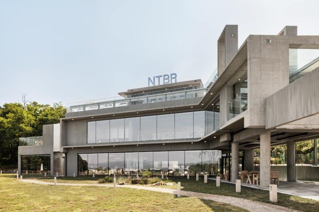 Exterior of NTBR café with exposed concrete and galvanized metal