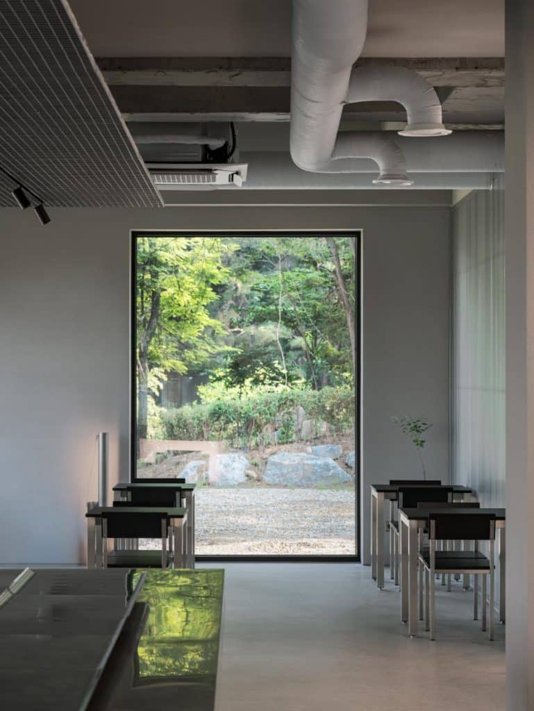 Counter area at NTBR café with planar lighting contrasting hall and work zone
