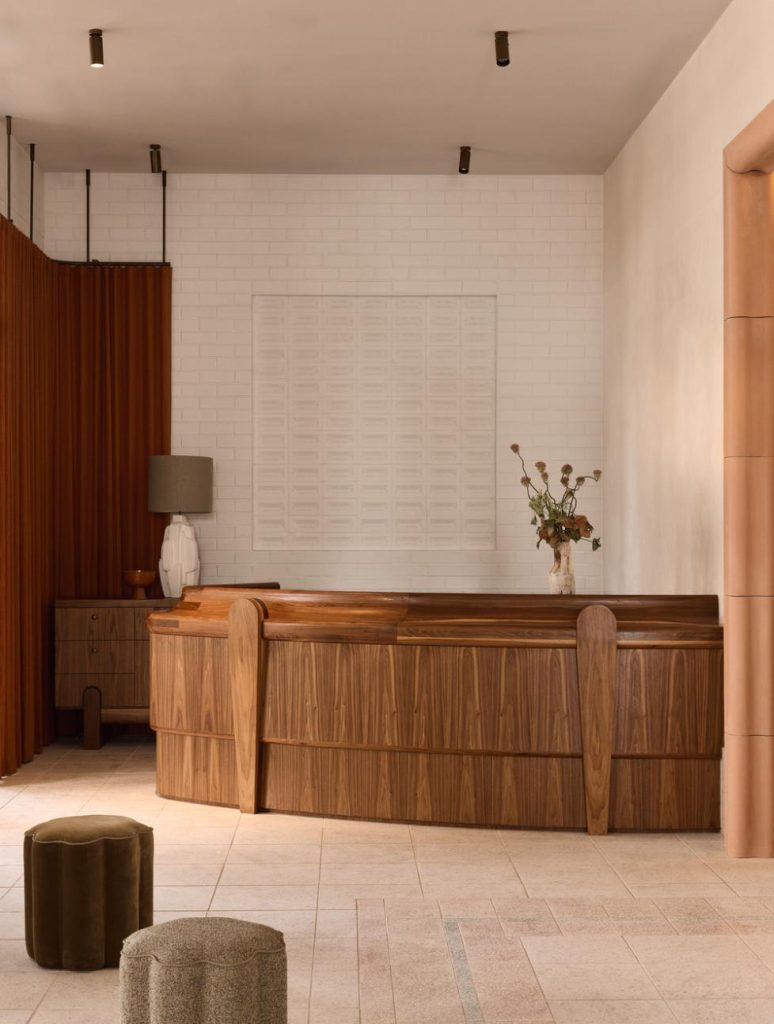 Reception area featuring the custom “Any Way You Want” brick wall artwork