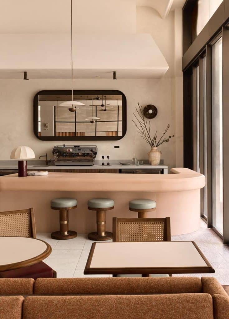 Haven restaurant interior with concrete bar and mirrored panels reflecting the pool deck