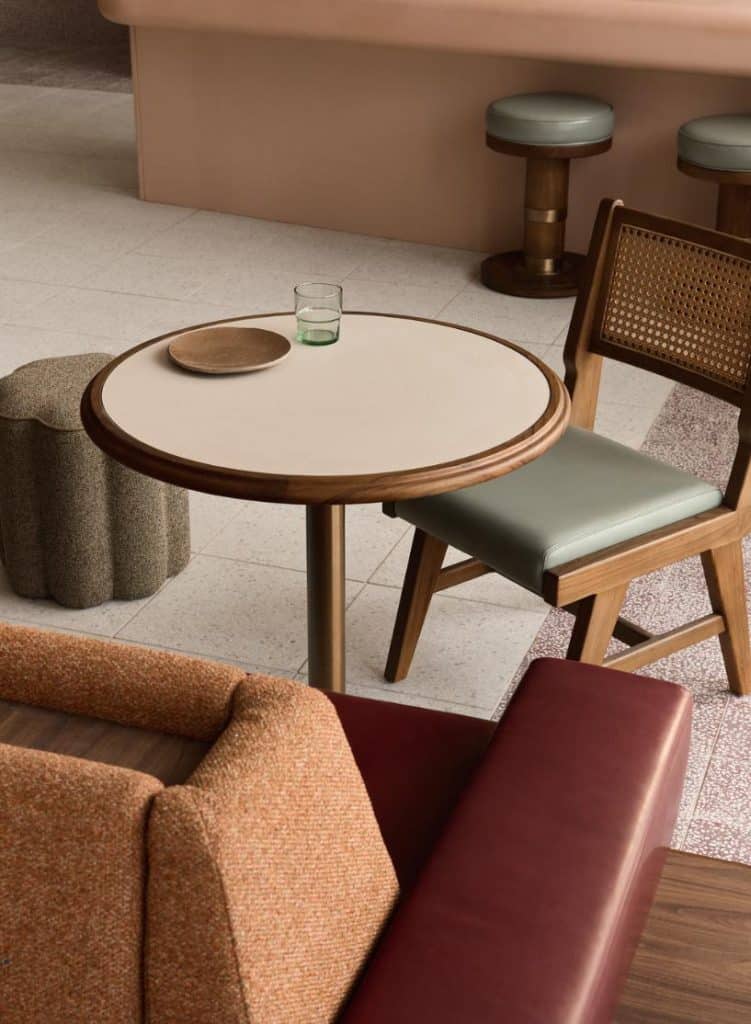Close-up of custom furniture in rust and sage tones within LiTO’s dining area