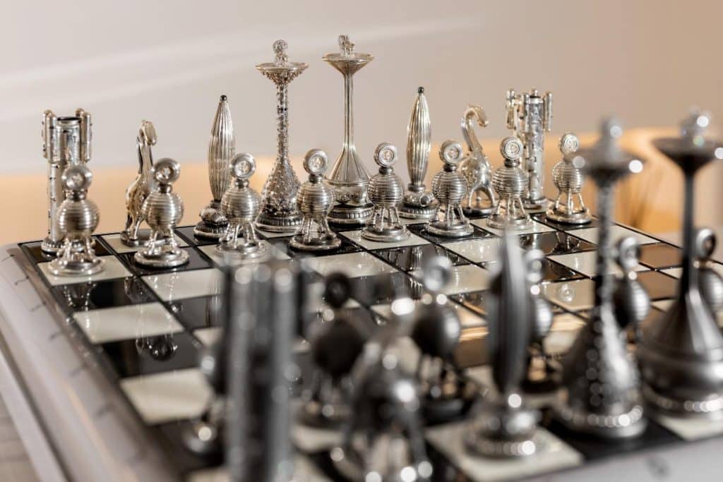 Silver and diamond chess set from Taras Yoom’s Diamond Age displayed on a dark surface