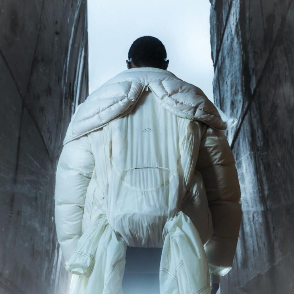 Model wearing Oakley Soar Puffer Jacket with adjustable features in urban environment