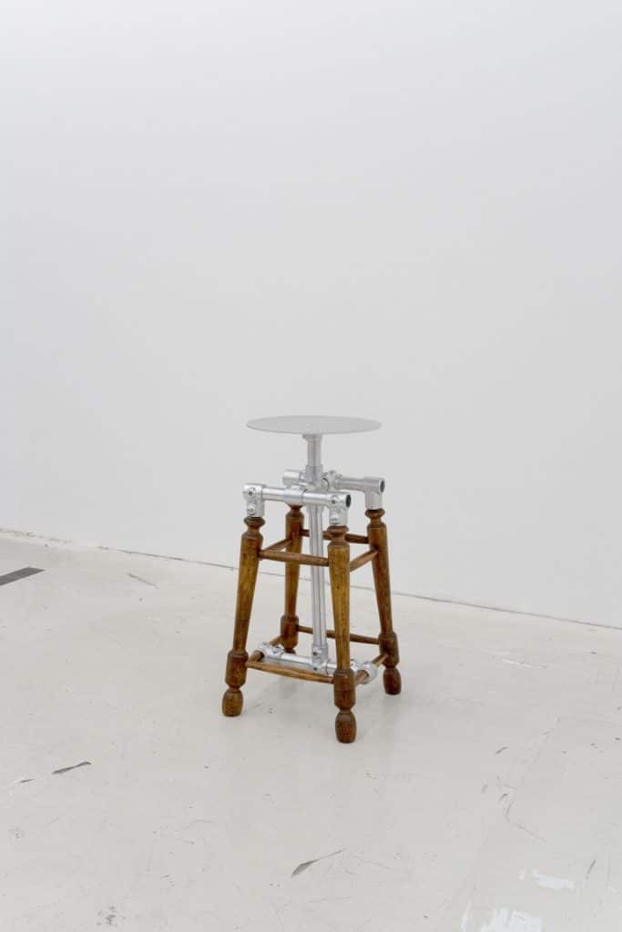 Elevated antique stool redesigned for fitting area inside New Balance space