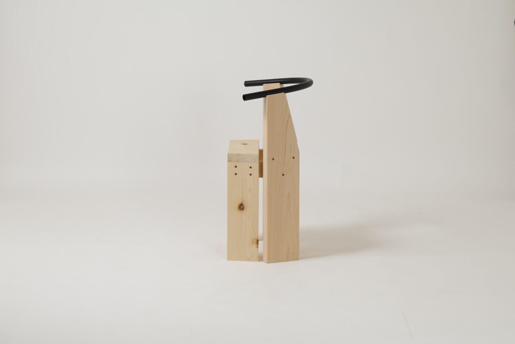 Side profile of Hiroi Chair emphasizing its wide seat and compact depth