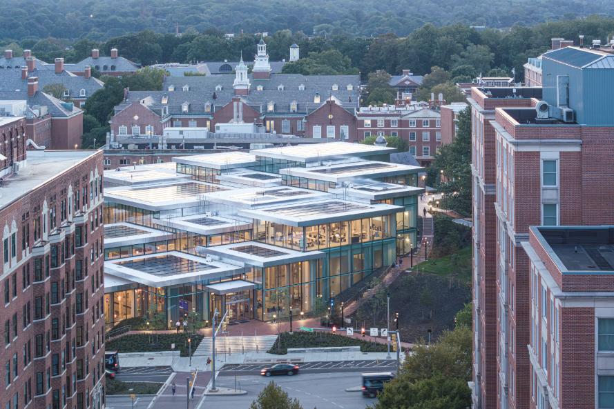 Nighttime view of the photovoltaic-paneled rooftop illuminating the campus