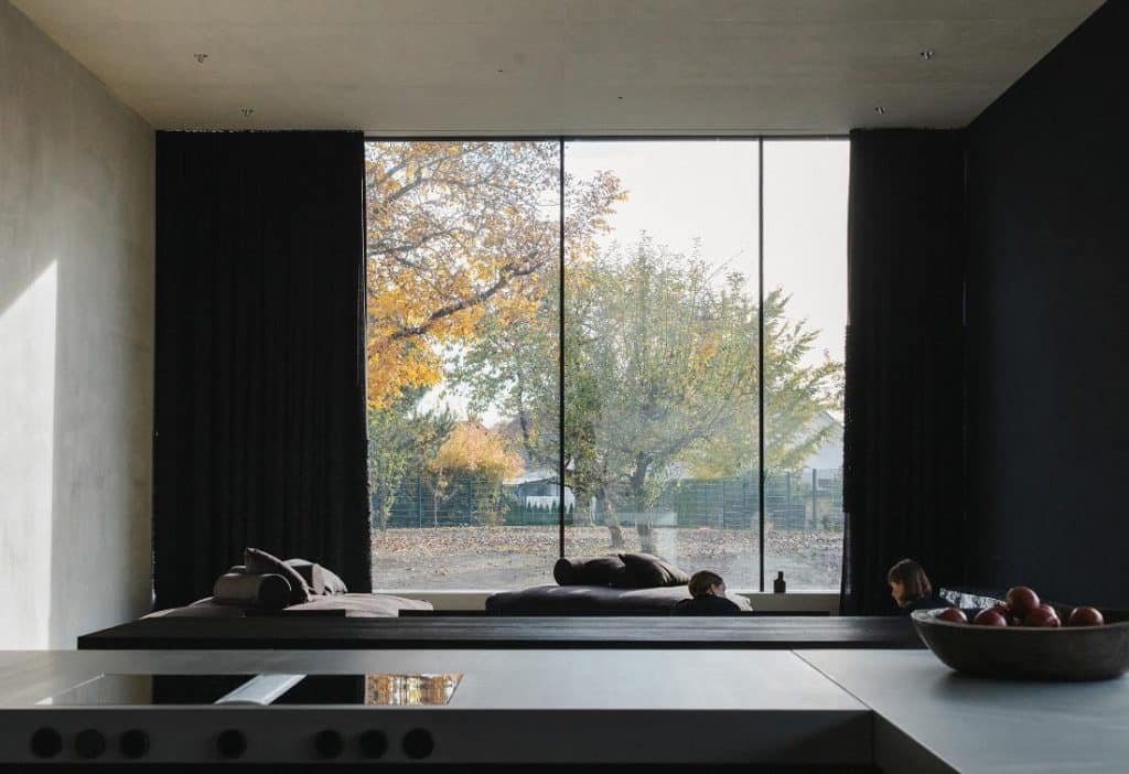 Panoramic living area with full-height glazing and handcrafted furniture
