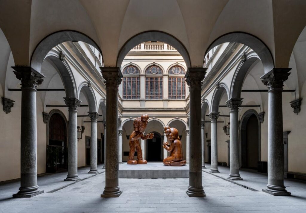 View of KAWS’ monumental wooden sculptures in the courtyard of Palazzo Strozzi