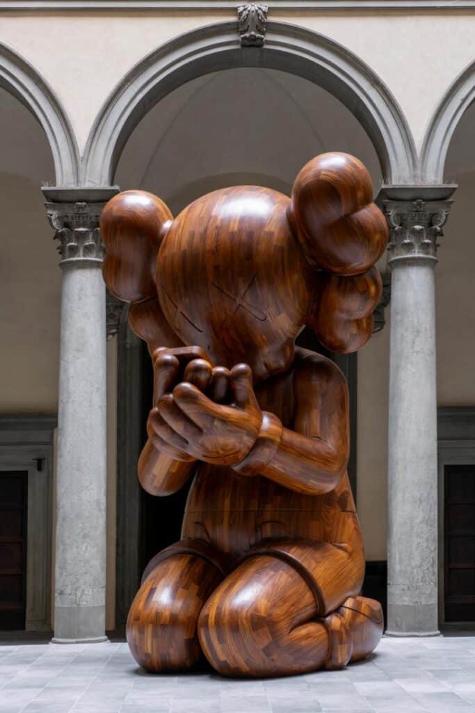 View of KAWS’ monumental wooden sculptures in the courtyard of Palazzo Strozzi