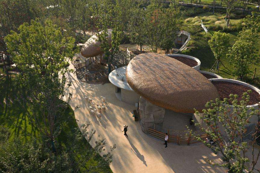 Meteorite-like farm structures set across a soft valley landscape