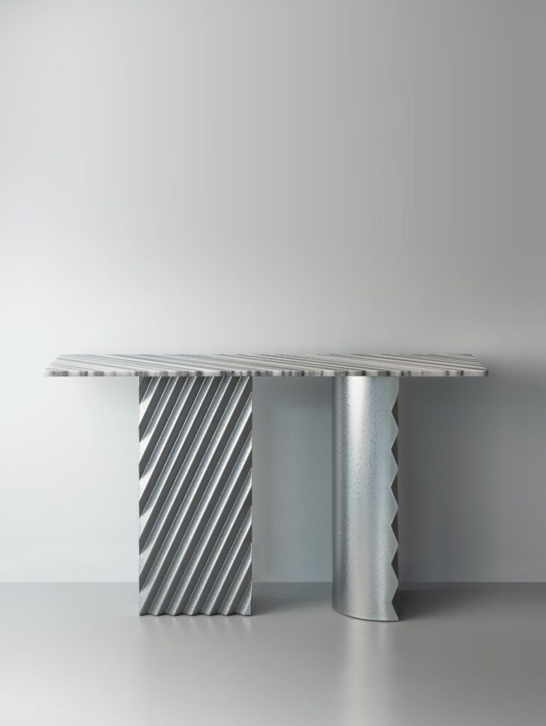 Marble and metal table revealing contrast of polished and textured surfaces