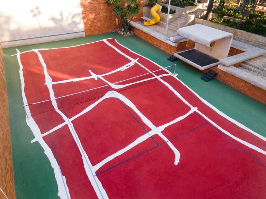 Hand-drawn tennis court lines painted across the Casa Axis hard court