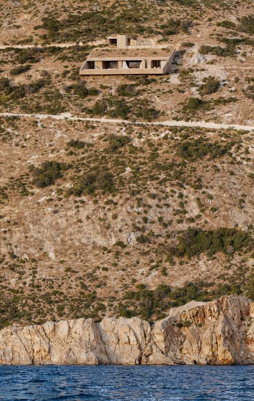 Aerial view of villa integrated into cliffside geometry