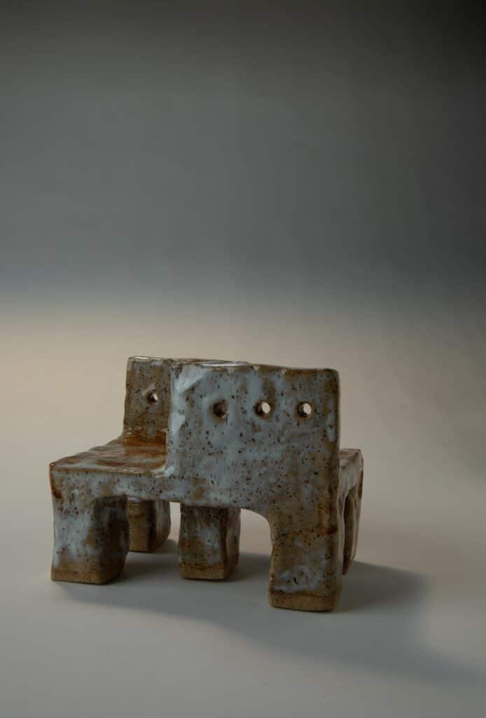 Close detail of a ceramic chair surface with subtle texture shifts