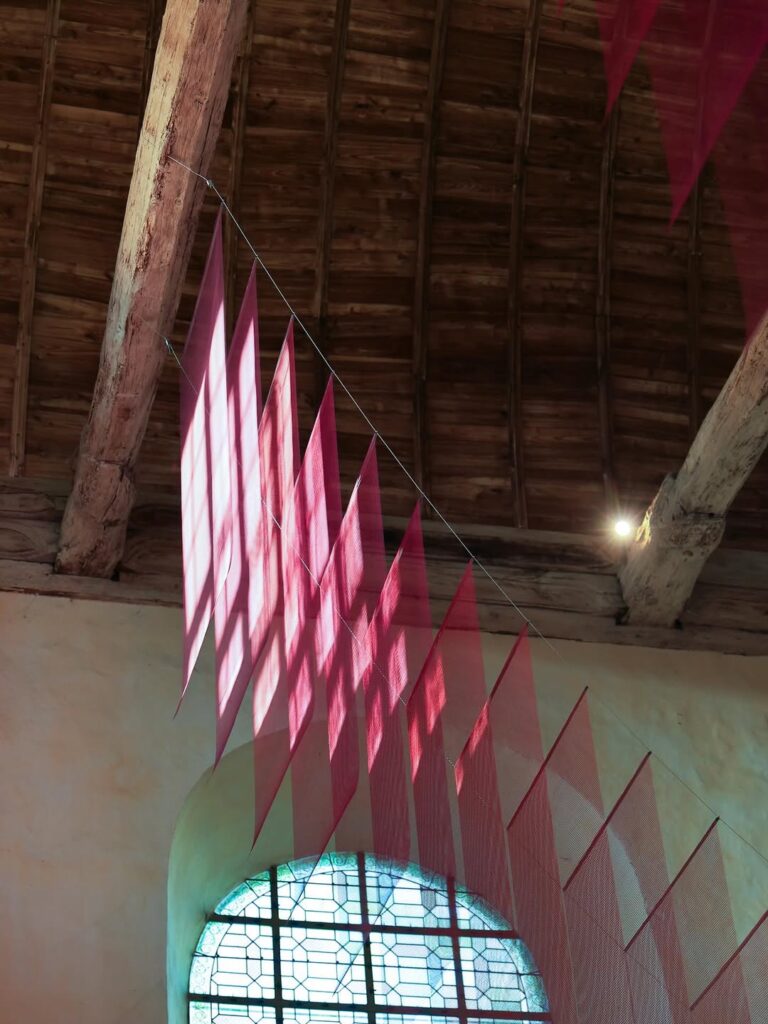 Floating fiberglass surfaces interacting with daylight from stained-glass windows