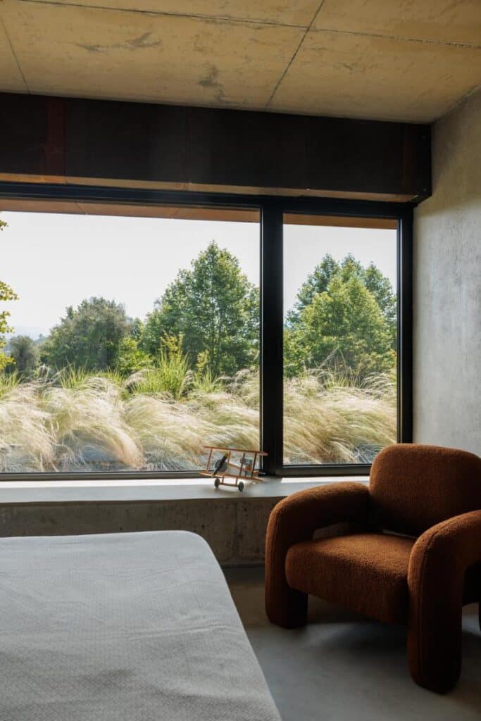 Casa Corten by HPA Arquitetura on a sloped industrial site -