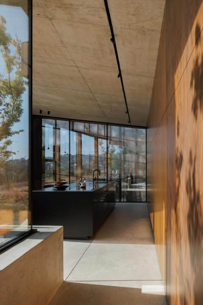 Casa Corten by HPA Arquitetura on a sloped industrial site -
