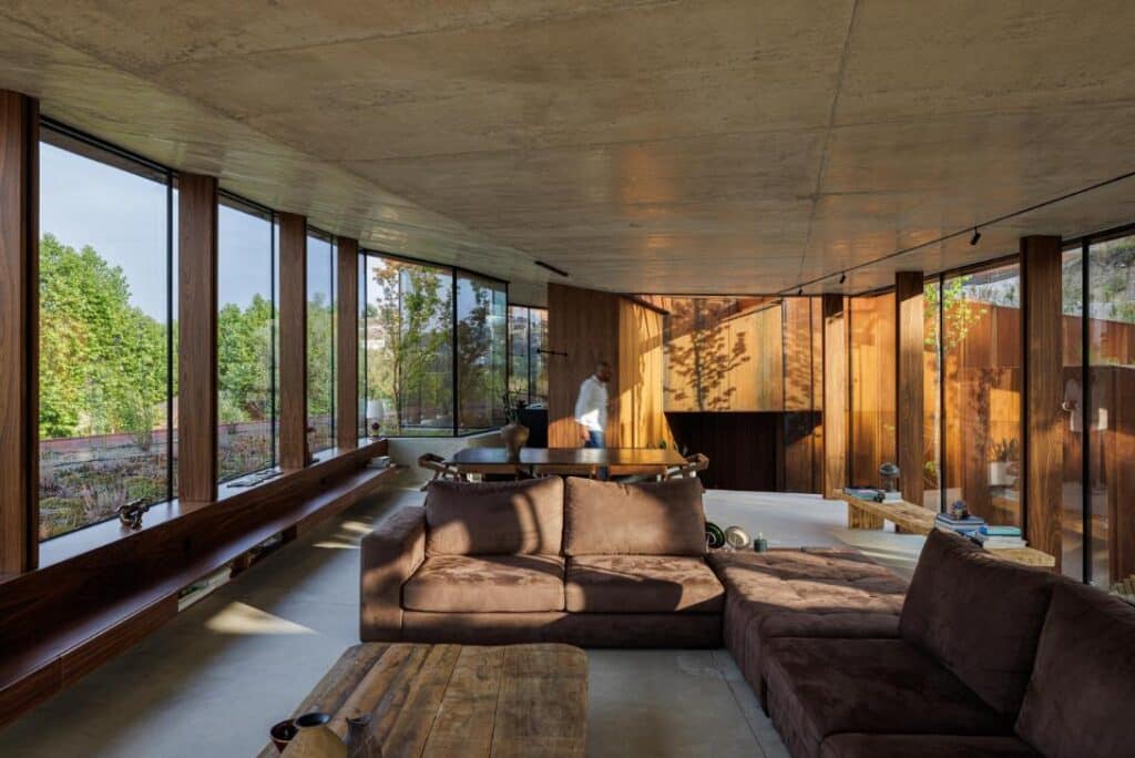 Casa Corten by HPA Arquitetura on a sloped industrial site -