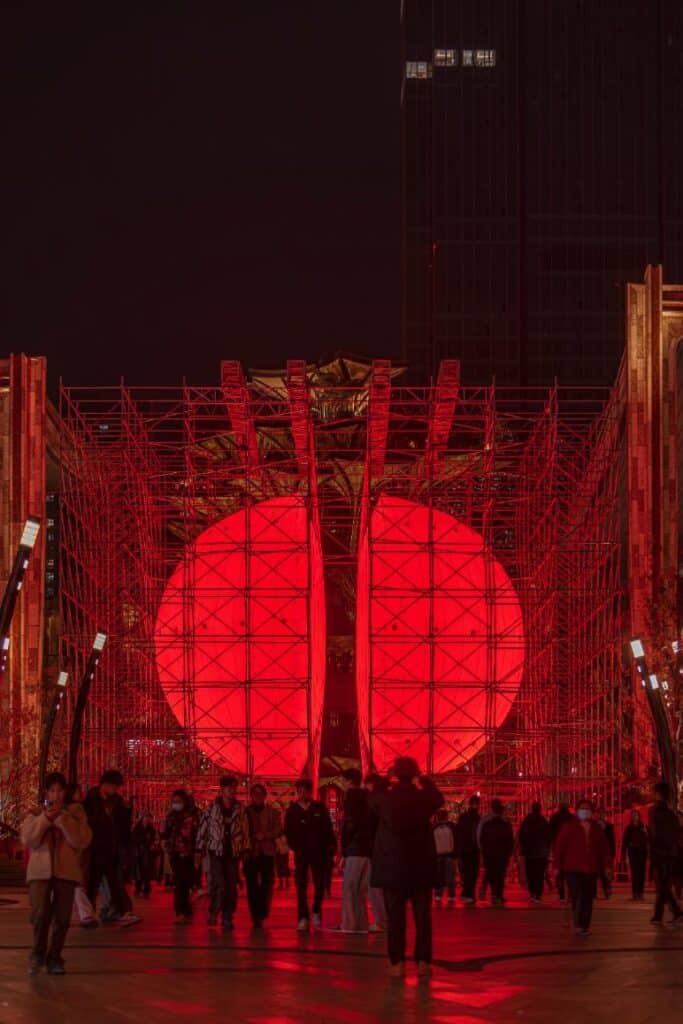 Visitors walking through the corridor of red light between halves