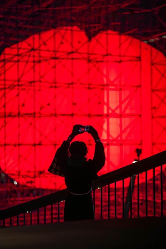 Audience approaching the monumental sphere in the plaza
