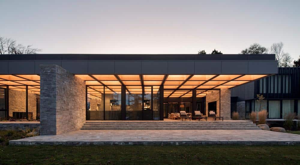 ACDF Architecture creates lakeside residence shaped by timber and stone