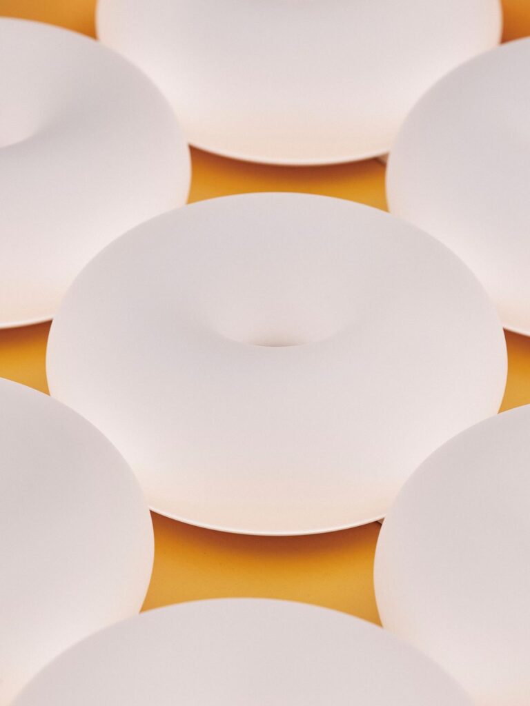 Close view of the smart donut lamp glowing in matte white glass