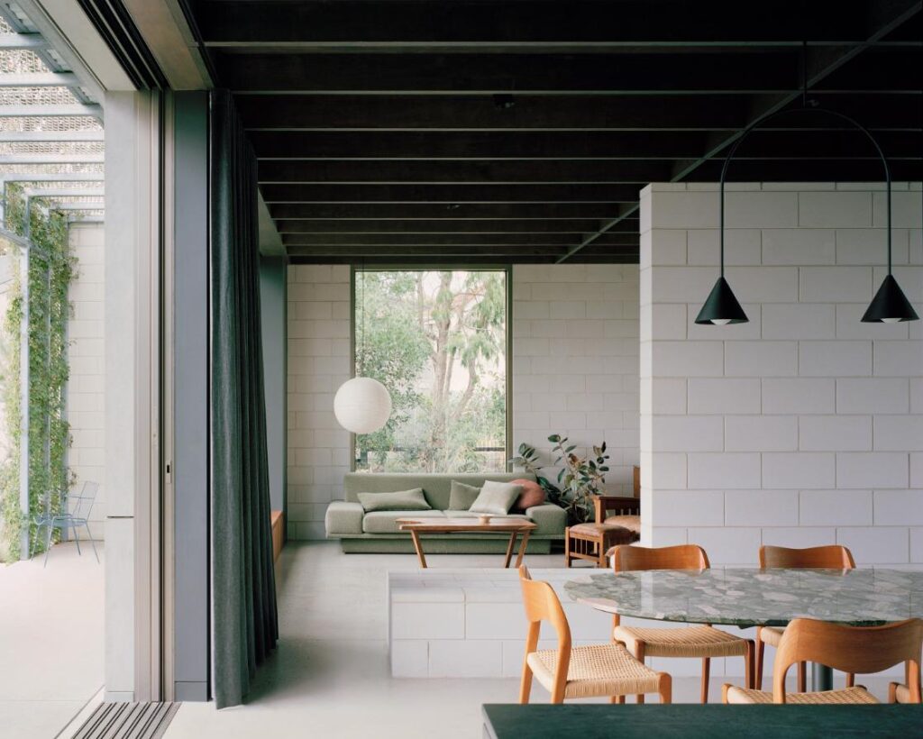 Living spaces opening to a sunlit garden at the intermediate level
