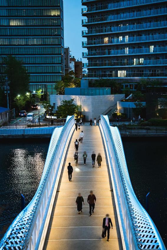 Footbridge arching toward Grand Marina Tokyo waterfront