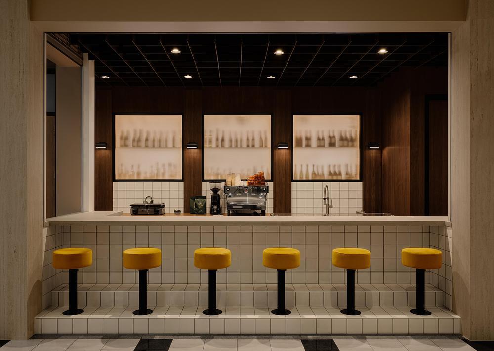 Interior view of tiled café counter with walnut partition