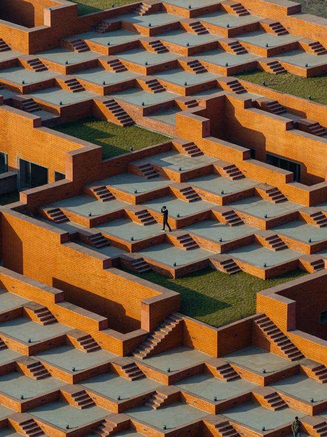 Sanjay Puri Architects uses stepped terraces for Prestige University Exterior view of Prestige University by Sanjay Puri Architects.
