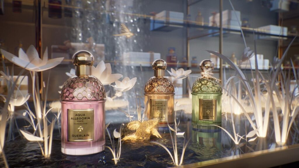 Aqua Allegoria perfume bottles displayed in glowing paper foliage with small luminous animal figure