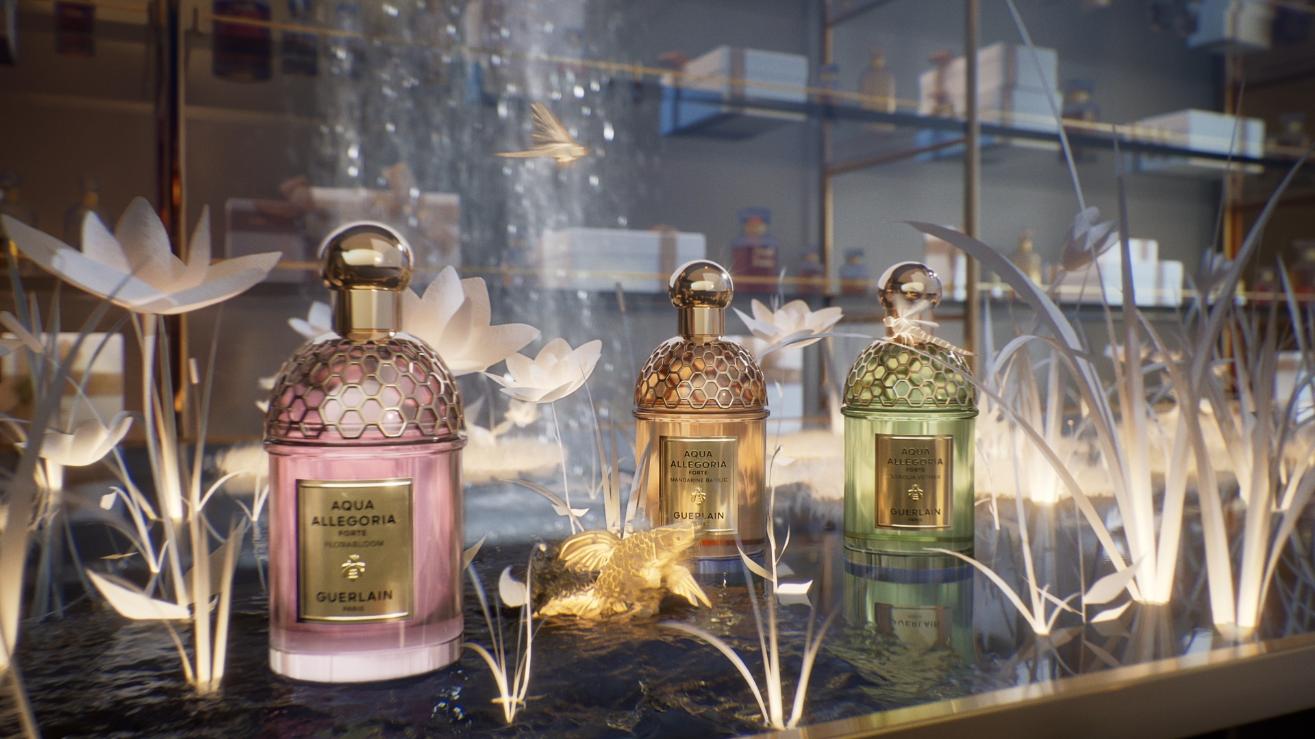 Aqua Allegoria perfume bottles displayed in glowing paper foliage with small luminous animal figure