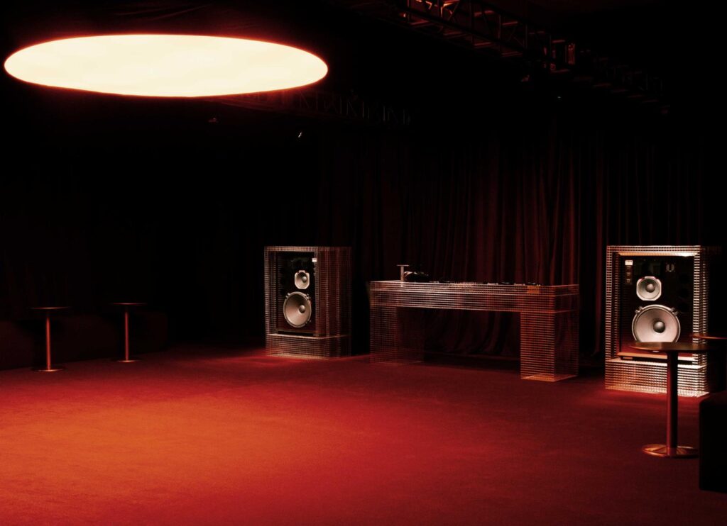 Installation overview showing mesh structures and speakers