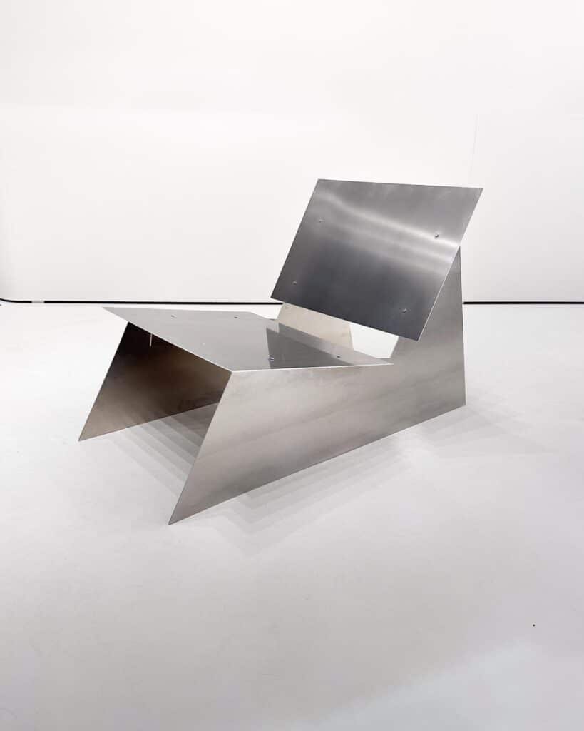 Pure aluminium lounge chair displayed in studio space