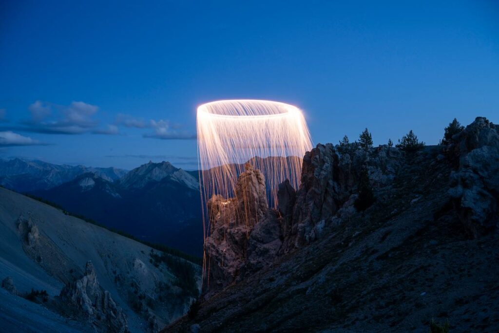 Mountain horizon illuminated by aerial light painting traces