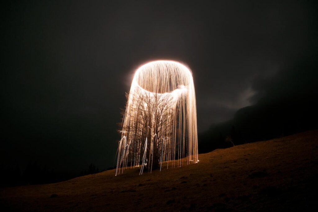 Cascading sparks forming graphic patterns across dark sky