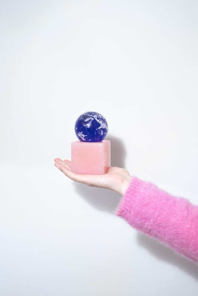 Lavender soap sphere placed on pink base