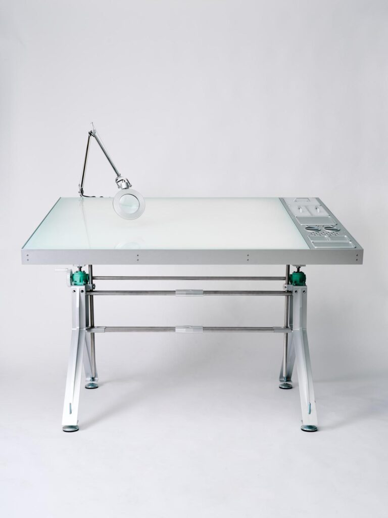 Backlit drawing surface with magnifying lamp for detailed charcoal work