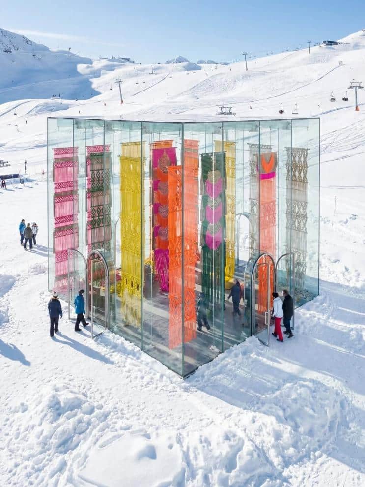 Overhead view of the Alpine glass pavilion with multiple entry arches and tall hand-knotted panels