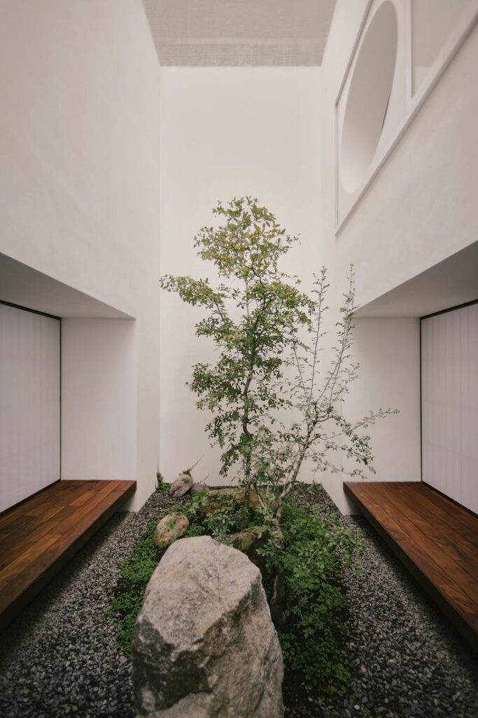 Kehai House by HW Studio built around a stone garden and central void -