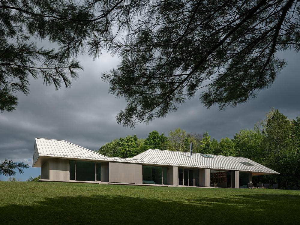 Superkül integrates Ridge House with landscape through sloping roof -